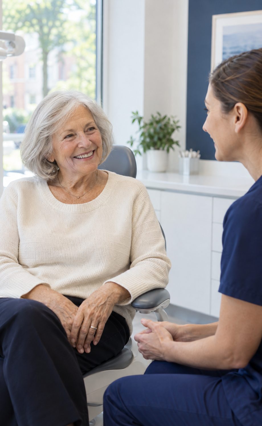 Older woman smiling while talking with a dental professional
